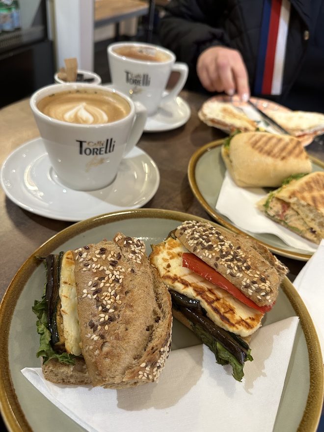 Toasted sandwich with Torelli cappuccino cups behind