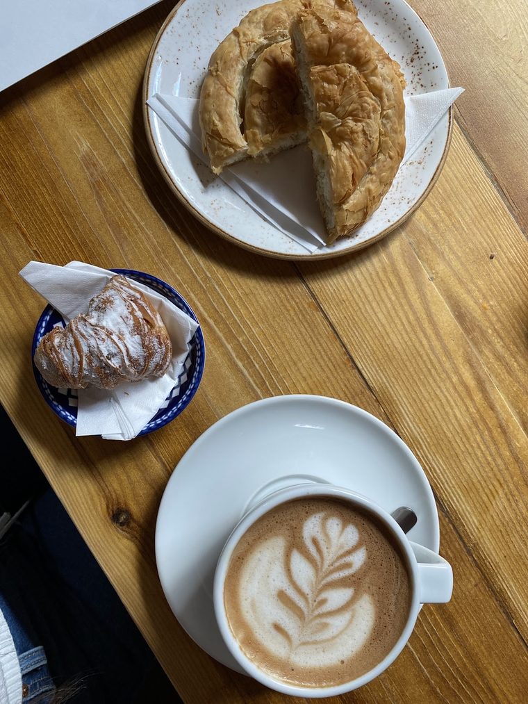 Cappuccino with latte art on a bare wooden table